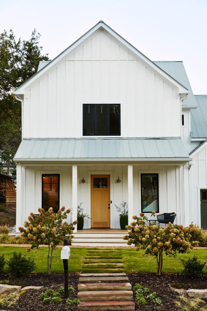 A welcoming home entry framed by green planting